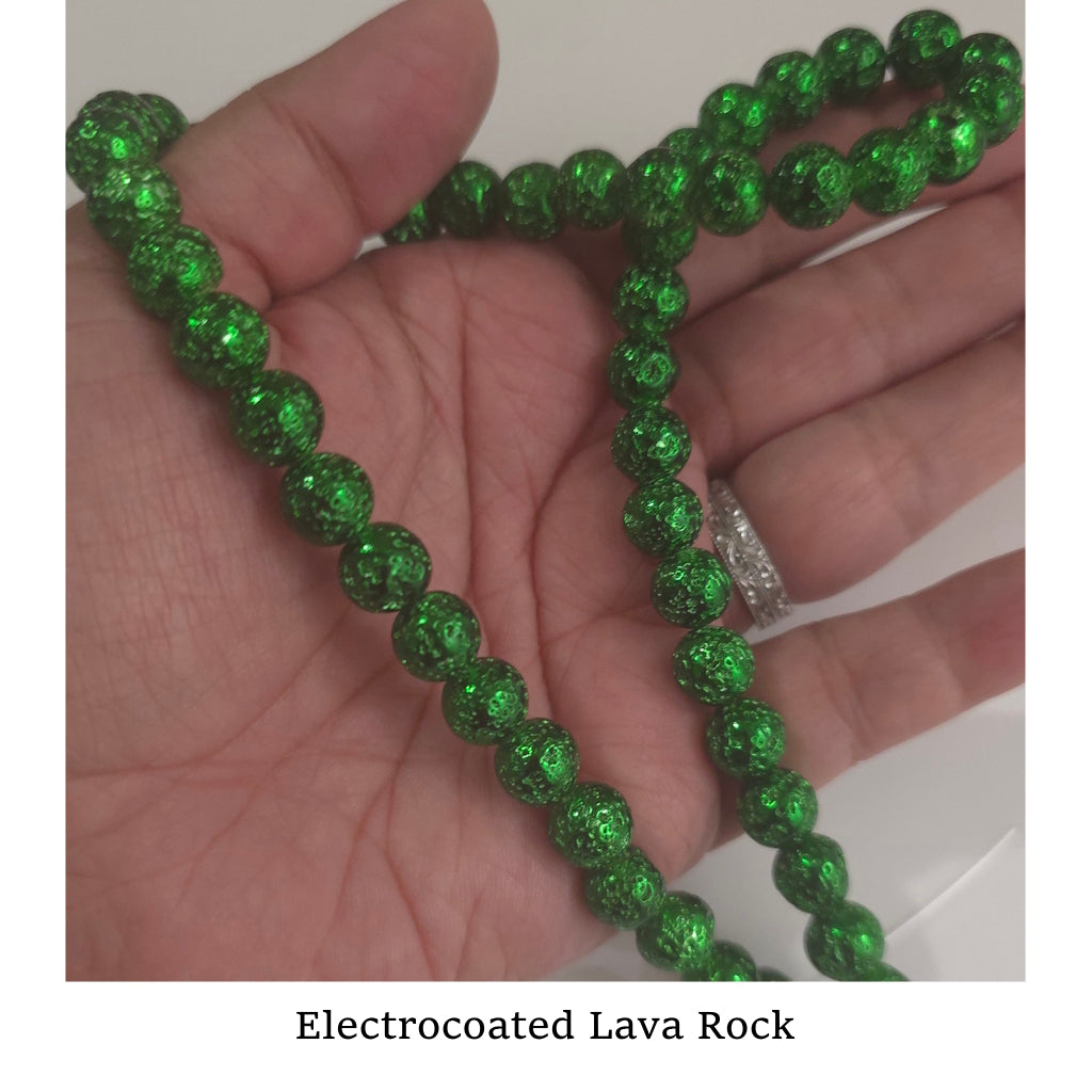 Electrocoated green lava rock bead strand held in a hand