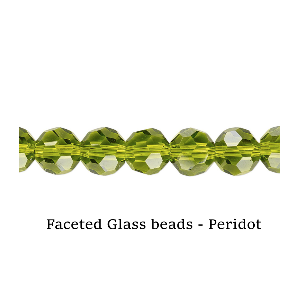 Faceted glass beads in peridot color on a white surface