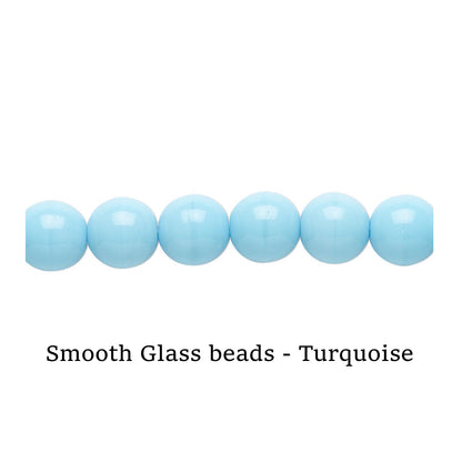 Turquoise smooth glass beads on a white surface