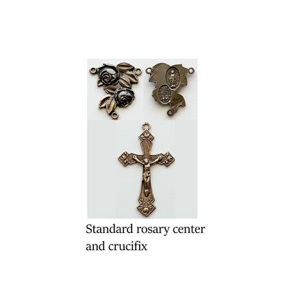 Bronze rosary center and crucifix on a white background